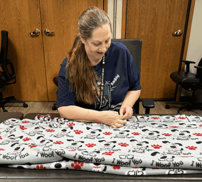 Volunteer working on no sew blankets