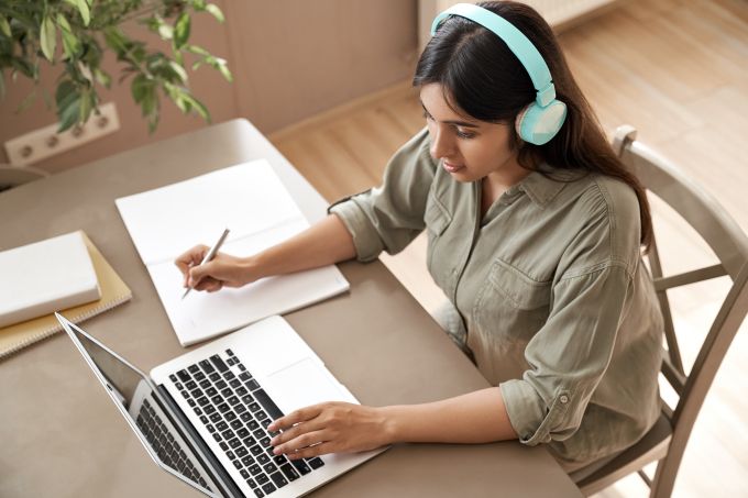 Young female student using laptop