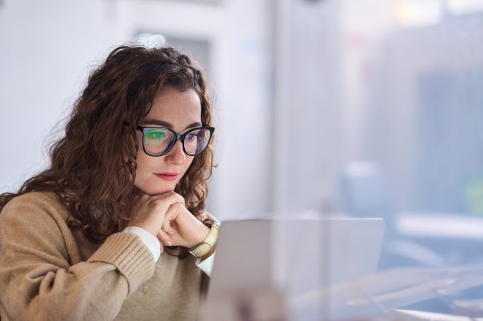 Young woman intently looking at her laptop screen