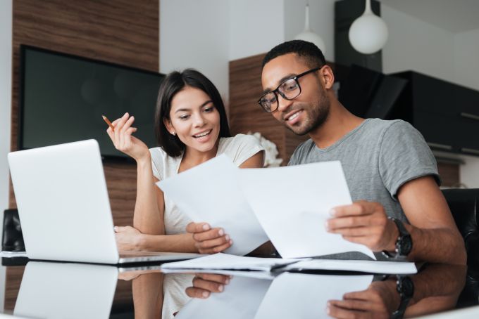 young couple looking over papers