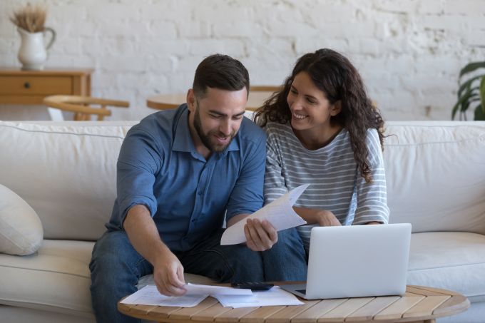 Couple sitting on couch budgeting