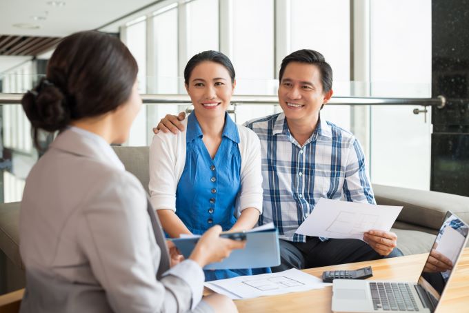 couple meets with a real estate agent