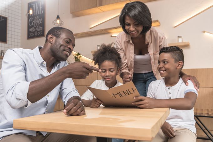 Family looking at pretend menu