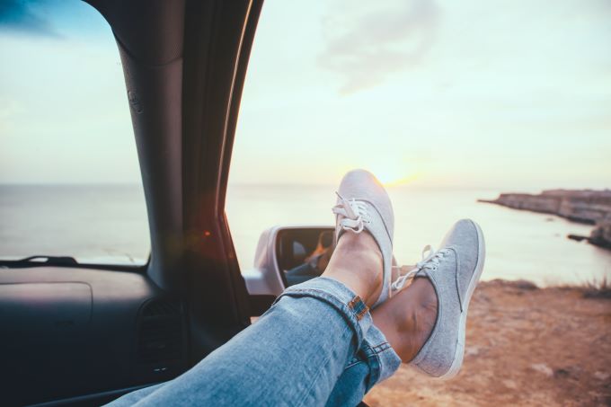 feet hanging out a car window