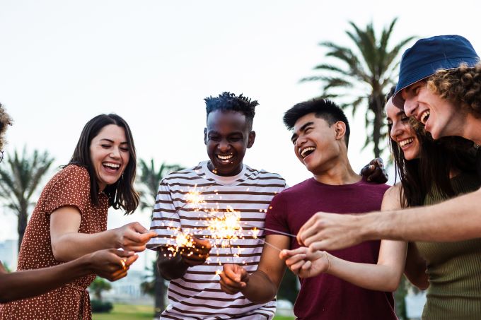 happy people lighting sparklers