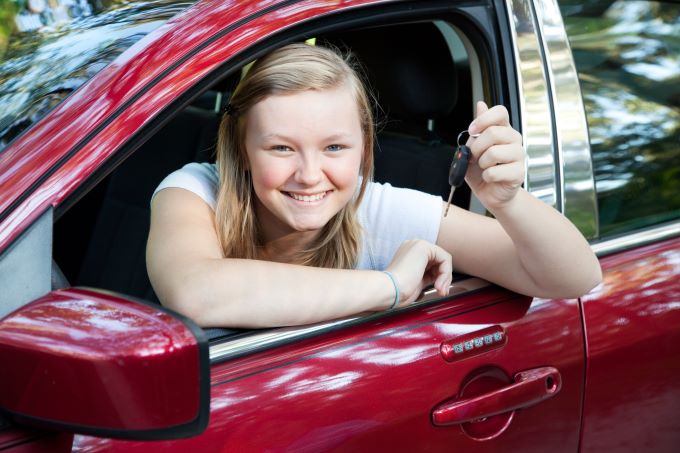 teenage girl driving newly purchased car