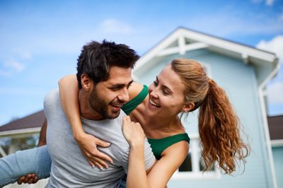 couple celebrates buying a house together
